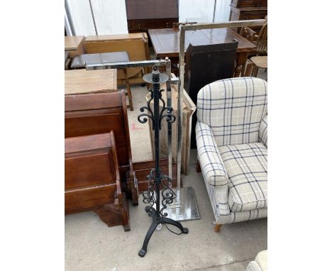 A WROUGH IRON STANDARD LAMP AND A CHROME ADJUSTABLE CLOTHES RACK 