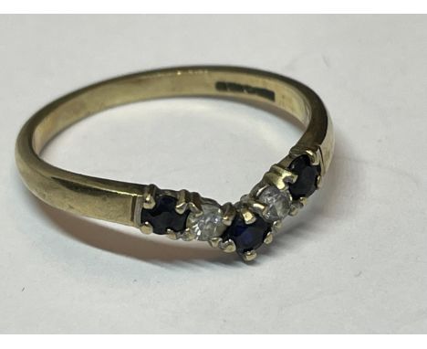 A 9 CARAT GOLD WISHBONE RING WITH THREE SAPPHIRES AND TWO CLEAR STONES SIZE L/M 