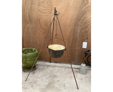 A VINTAGE CAST IRON COOKING POT WITH TRIPOD STAND 