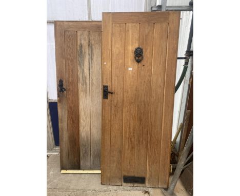 TWO LARGE OAK DOORS ONE WITH DOOR KNOCKER, ONE MEASURING 78" X 32" AND THE OTHER 75.25" X 36.5"