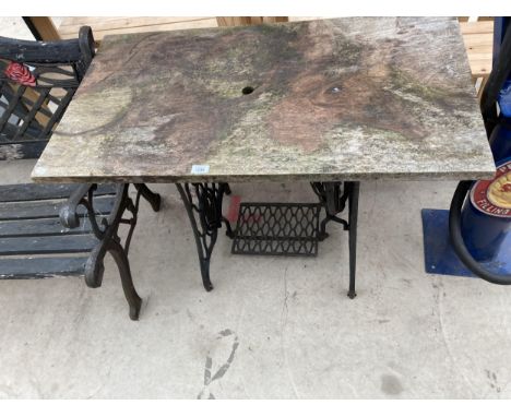 A VINTAGE WOODEN TOPPED TABLE WITH CAST IRON TREDDLE BASE 