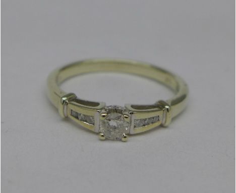 A 9ct white gold and diamond solitaire ring with diamond shoulders, 2.4g, M