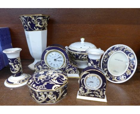 Eight items of Wedgwood Cornucopia china comprising a pair of candlesticks, a vase, photograph frame, two clocks, trinket box