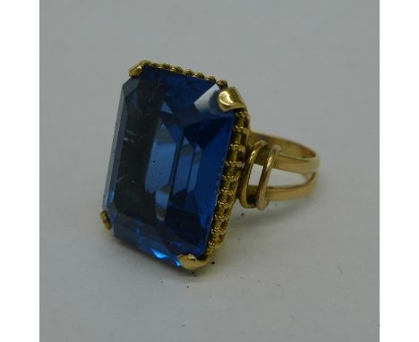 A yellow metal and blue stone ring, 11.1g, O