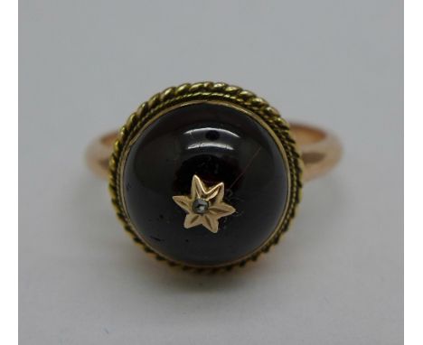 A 9ct gold set, cabochon garnet and diamond ring, 3.5g, O