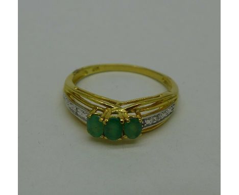 A silver gilt, emerald and diamond ring, S