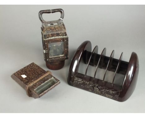 A Bakelite cased trench viewer, a pair of Bakelite cased swing handled lanterns, a five-division book or magazine rack moulde