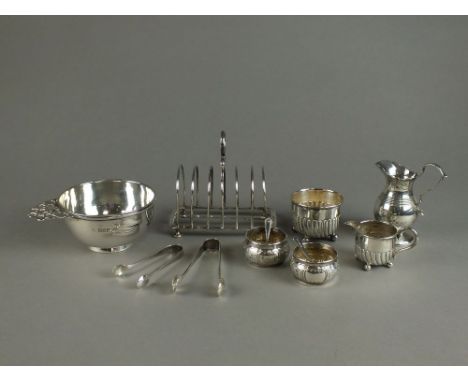 A silver six division toast rack, Sheffield, together with a silver baluster cream jug, London, a wrythen embossed silver cre