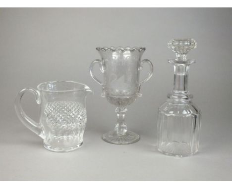A selection of cut glass to include decanters and stoppers, a large jug, a celery glass engraved with a swan, a small cut gla