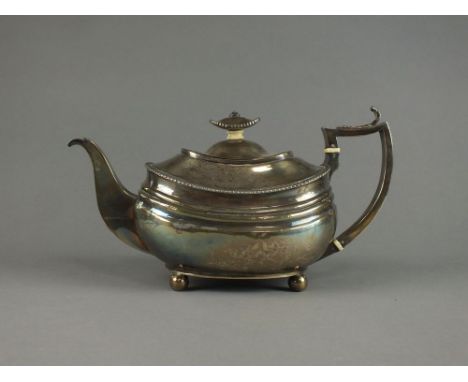 A silver boat shaped teapot, marks rubbed, with gadrooned rim, acanthus leaf capped handle with ivory spacers and ivory space