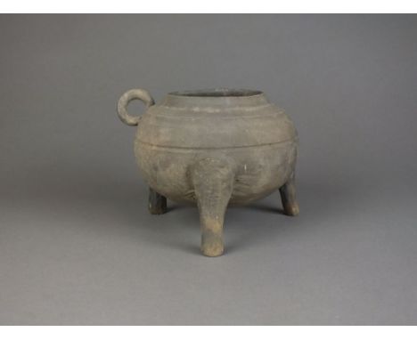 A Chinese stoneware tripod censer Possibly Han Dynasty Of compressed globular form with ring handles, raised on three shaped 
