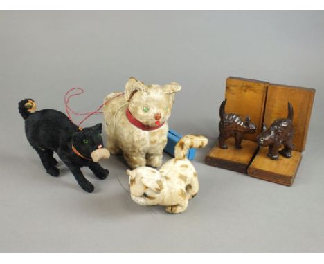 Two trays of cat ornaments including three carved sleeping cats, a pair of ceramic cat book ends, a pair of carved cat book e