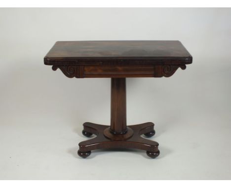 A William IV rosewood card table, the rectangular fold-over top enclosing a red baize lined playing surface above a frieze wi