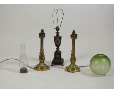 A pair of cast brass foliate wrapped candle sticks, each on hexagonal base, an etched glass shade and chimney, 40cm high and 