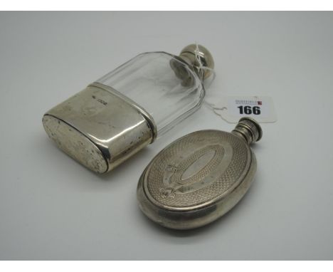 A Hallmarked Silver Mounted Glass Hip Flask, PW(?), London 1913, with removable base cup and swivel top (dented), 14cm high; 