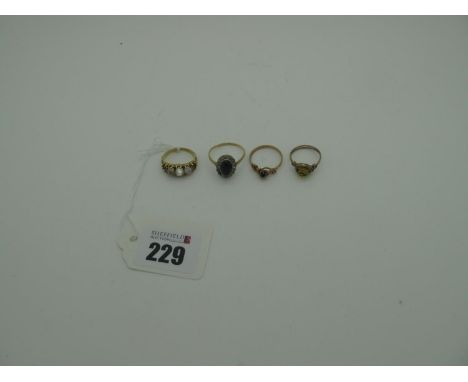A XIX Century Moonstone Ring, graduated cabochon set (two missing) between textured shoulders (finger size L), two wire dress
