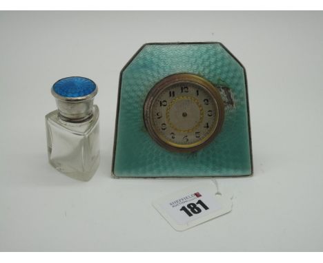 An Enamel Bedside Clock, stamped "Sterling Silver" (damages) the circular dial with black Arabic numerals (lacking hands), on