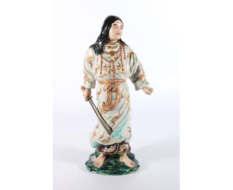 Chinese pottery figure of a warrior modelled standing holding sword, 35cm tall.  Repair at the back of the base. Heavy crazin