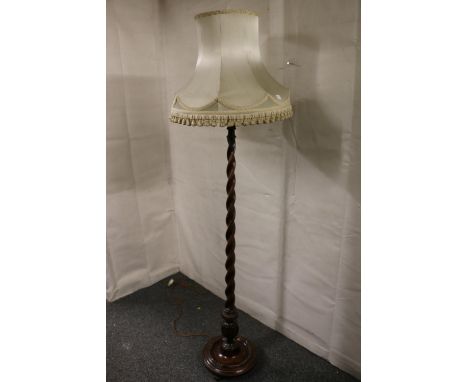 Early 20th century oak standard lamp raised on barley twist column. 