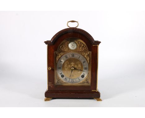 Elliott mantle clock in mahogany arch top cased retailed by Owen and Robinson Ltd of Leeds, the movement sticking on a bell, 