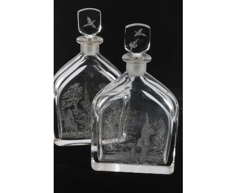 Pair of Orrefors Zaglo art glass decanters decorated with etched hunting scenes, 28cm tall.&nbsp; 
