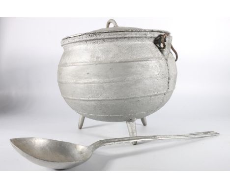 Light weight white metal cauldron with cover, 33cm diameter and a 'ONO' light weight white metal ladle. (2) 