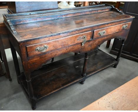 A Georgian Scottish oak low dresser, with raised rear platform and two frieze drawers, on turned supports with pot-shelf, 135