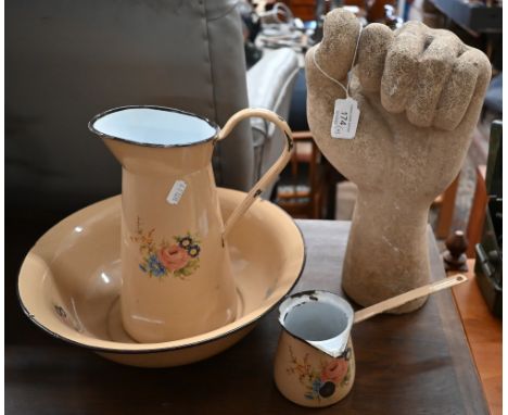 Cast stone 'clenched fist' 33 cm to/w a floral-printed enamel ewer and basin with matching pan (4) 