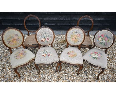 A set of Victorian balloon back salon chairs with floral carving and cabriole front legs with floral tapestry upholstery, 2 a