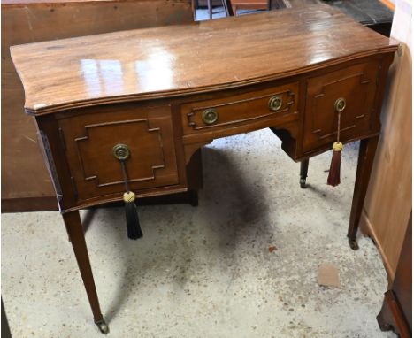 A late Victorian mahogany serpentine kneehole side table/desk, on square tapered legs to ceramic castors, 104 x 50 x 76 cm h 