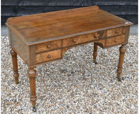 Victorian walnut and burr writing table by Holland & Sons with five drawers around a kneehole, on turned and fluted supports 