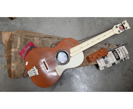 A 1950s plastic 'Elvis Presley Guitar' in original cardboard box, to/w a marbled plastic 'Guitar Auto-Chord' device (2) 