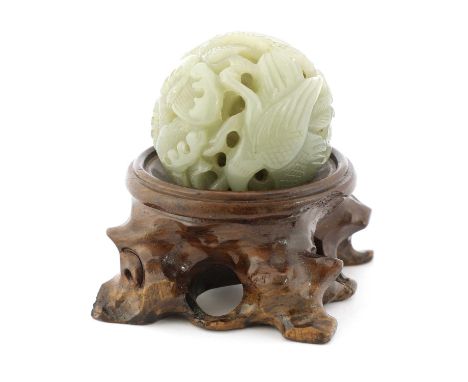 A Chinese jade ball, pierced and carved with a bird in a lotus pond, 5cm diameter, associated wood stand (2)Condition report:
