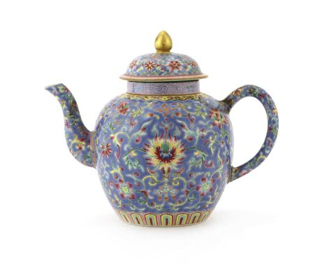 A Chinese famille rose teapot and cover, of ovoid form, painted with scrolling lotus against a blue ground, six-character Dao