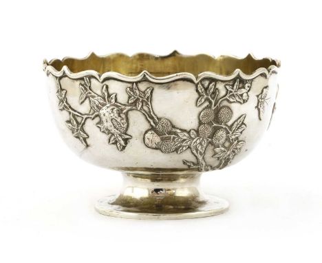 A Chinese silver stem bowl,early 20th century, of circular form with lobed rim on a collet foot, decorated in relief with a b