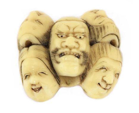 A Japanese ivory netsuke, Meiji period (1868-1912), carved with seven Noh masks, signed to base, 4cm longCondition report: Iv