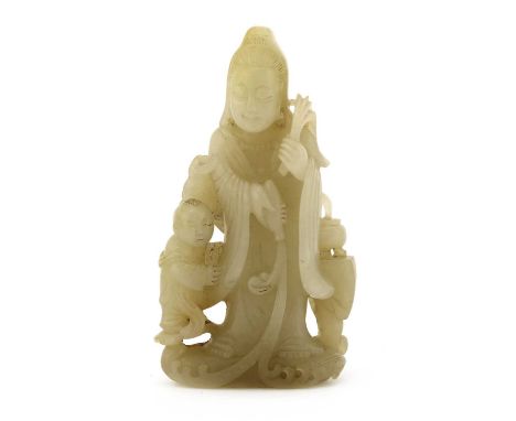 A Chinese jade carving, of guanyin in a long robe standing on waves, with a boy holding lotus to her right side and an incens