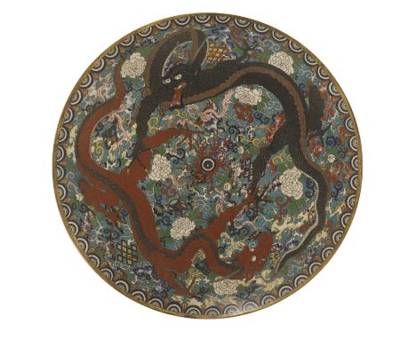 A Japanese cloisonné charger, Meiji period (1868-1912), enamelled with two dragons chasing a flaming pearl among scrolling pe