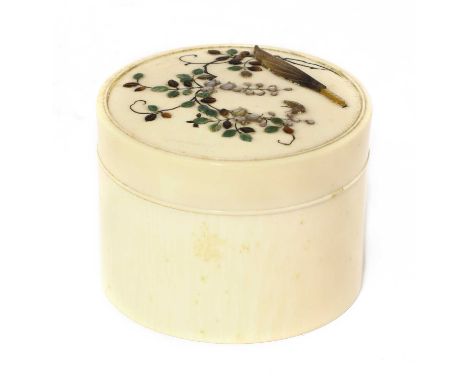 A Japanese ivory box and cover,early 20th century, of circular form, the cover inlaid with a blossoming branch in mother-of-p