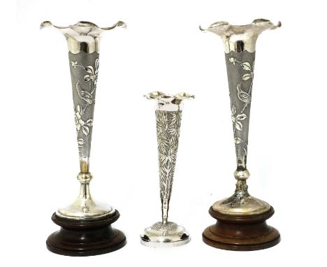 A pair of Chinese export silver repoussé vases,early 20th century, each of tapering form with a lobed rim on a pedestal foot,