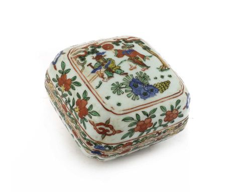 A Chinese wucai box and cover, of shaped square form, the domed cover painted with two figures under a pine tree, enclosed by