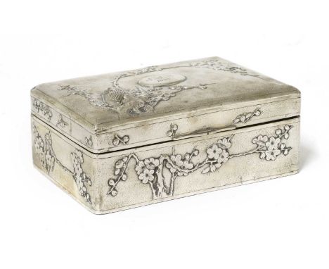 A Chinese export silver cigarette box,early 20th century, of rectangular form, decorated in relief with an owl on a blossomin