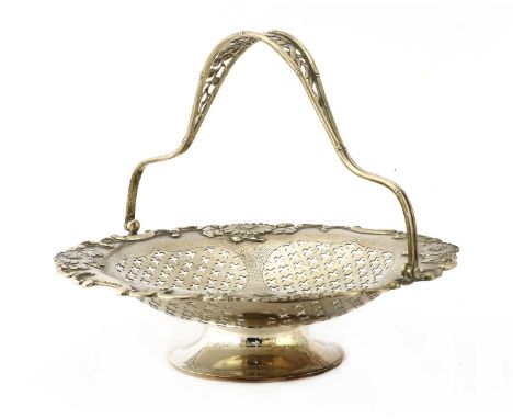 A Chinese export silver swing-handled fruit basket, early 20th century, of shaped circular form on a flared circular foot, wi