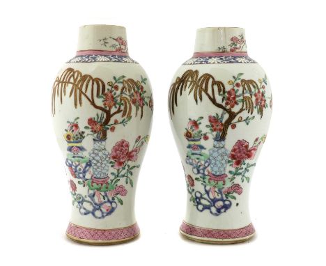 A pair of Chinese export famille rose vases, 18th century, each of baluster form, painted with willow and prunus branches com
