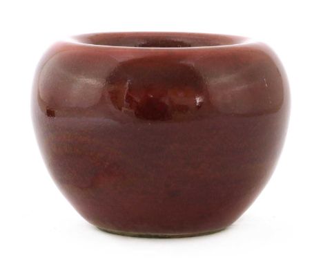A Chinese sang-de-boeuf water pot,Republic period (1912-1949), of compressed globular form with rounded sides rising from a c