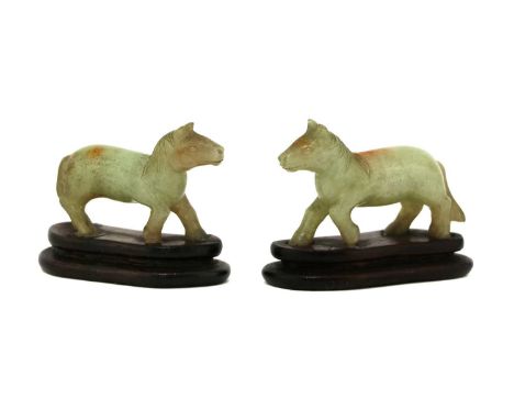 A pair of Chinese jade carvings, of horses, 5.5cm long, wood stands (2)Condition report: Both glued to wood stands. Minute ch