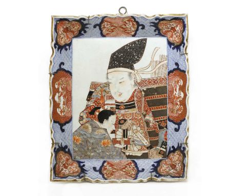 A large Japanese Imari dish,Meiji period (1868-1912), of rectangular form with a raised lobed rim, painted with an attendant 