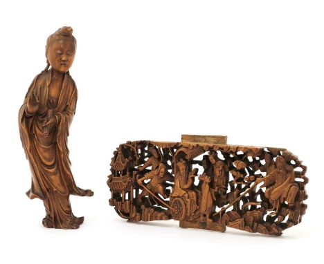 A Chinese boxwood panel, 19th century, pierced and carved with figures in a rocky landscape, 19cm long, and a boxwood guanyin