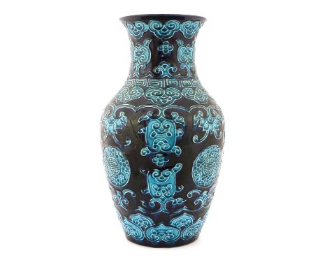 A Japanese aubergine and turquoise-glazed vase,19th century, of baluster form rising to a flared rim, decorated in relief wit