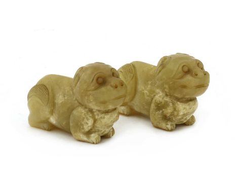 A pair of Chinese jade carvings, Ming dynasty (1368-1644), each recumbent mythical beast with its head alertly facing forward